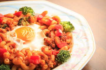 Stir-fried macaroni and pork on wooden background