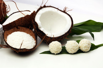 Tasty candies in coconut flakes on plate
