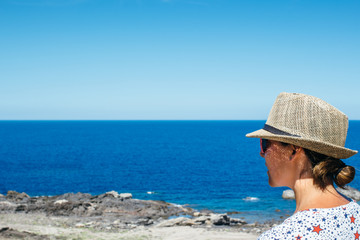 Woman admiring ocean from coast