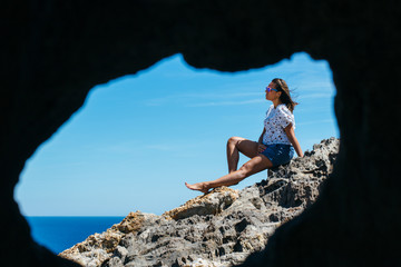 Woman sitting on stone