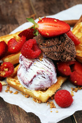 belgian waffles with ice cream, caramel sauce and fresh berries