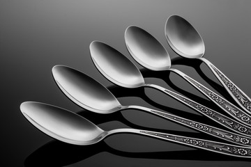 A set of spoons on black background