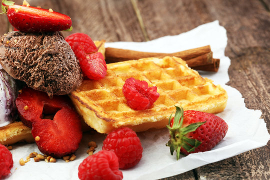 belgian waffles with ice cream, caramel sauce and fresh berries