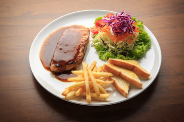 Fototapeta na wymiar Pork chops with Black Thai Chili Sauce wooden background