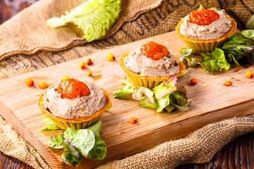 Tartlets with liver pate from duck or chicken livers and a sauce of sea-buckthorn are on the Board.