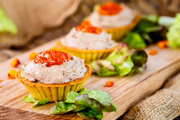 Tartlets with liver pate from duck or chicken livers and a sauce of sea-buckthorn are on the Board.