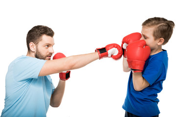 Happy father with son during boxing training isolated on white