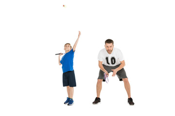 active father and son playing tennis together isolated on white