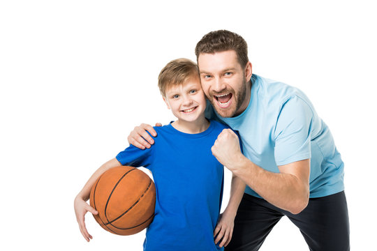 father and child ready to play basketball and looking at camera isolated on white