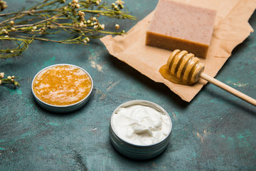 Close-up view of handmade soap, honey, dried flowers and cream for beauty care