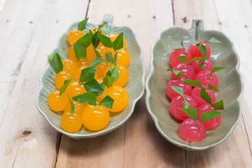 Several orange and Cherry balls in a tile dish.