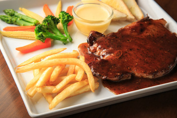 Pork chops with Black Thai Chili Sauce wooden background
