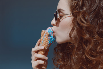 close up portrait of red hair girl in sunglasses eating ice cream, hipster girl