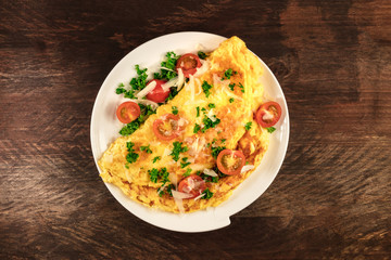 Omelette with parsley, cherry tomatoes, and copyspace