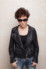 Obraz premium short hair girl in glasses and fancy leather jacket