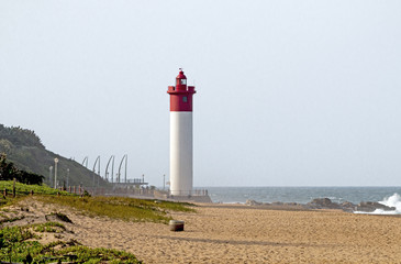 Green Vegetation Beach and RedLlighthouse Seascape