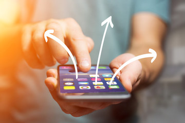 Hand drawn arrows icon going out a smartphone interface of a man at the office - Ideas concept