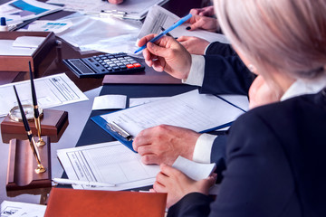 Business people office life of team working with papers sitting table with schemas and diagrams...