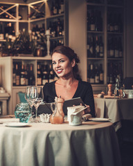 Woman reading menu in a restaurant