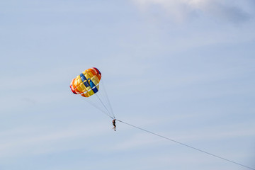 man parasailing on blue sky