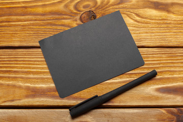 Mockup of black paper on wooden table