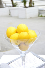 Glass with lemons at the seashore with palm trees