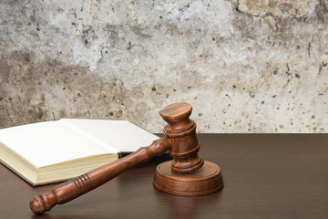 Wooden gavel and books on wooden table