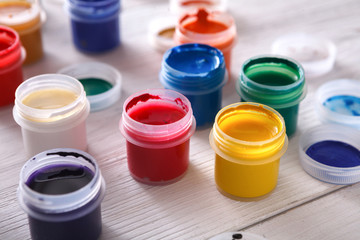 Artist workplace, set of color paints on wood desk