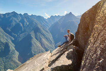 Man sit on mountain peak