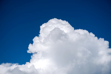 Naklejka na ściany i meble Close-up Cumulus cloud on blue sky