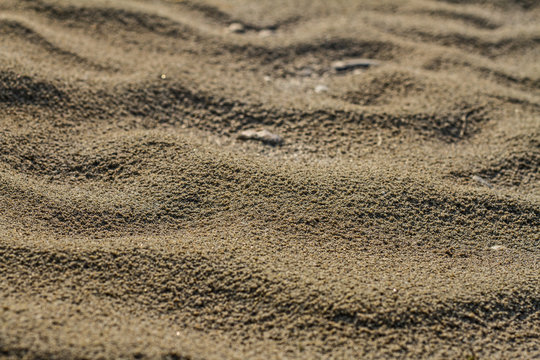A texture of river brown sand in summer on a sunny day in the desert.
