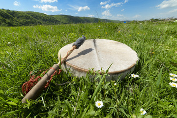 Shamanic tambourine on a meadow