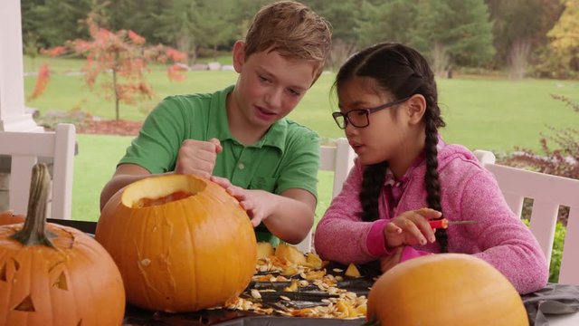 Kids carving pumpkins for Halloween