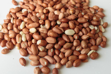Vegan food. Peanuts for roasting on a white table