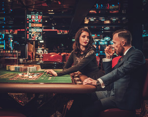 Upper class couple gambling in a casino