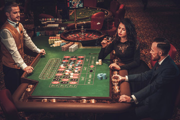 Upper class couple gambling in a casino
