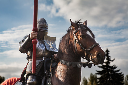 Knight on horseback. Horse in armor with knight holding lance. Horses on the medieval battlefield.