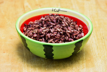 A cup of sticky rice from Thailand,colour rice,red rice