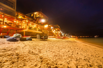 Tourists enjoy Chaweng Beach nightlife at Koh Samui beachside restaurant & bar - Thailand