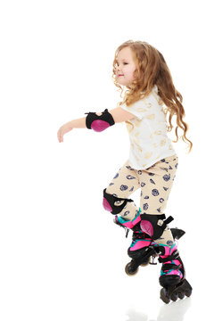 Little girl roller-skates.