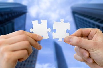 man and woman hand holding jigsaw puzzles, business matching concept