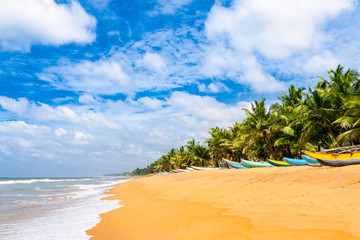 Fishing boats resting on empty beach in Sri Lanka