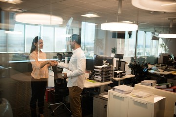 Fototapeta premium Business colleagues shaking hands in office