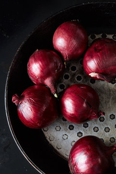 Sliced red spanish onion on vintage frying pan