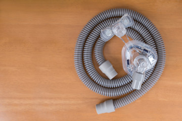 Pair of CPAP mask and tubing..Cleaning cpap mask and tubing is a routine job,selective focus on cpap mask,flat lay
