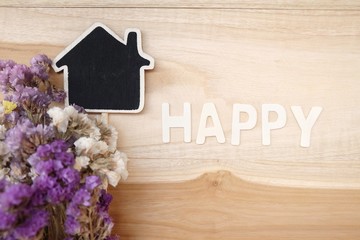 Wooden house models and bouquets for happy family concept.