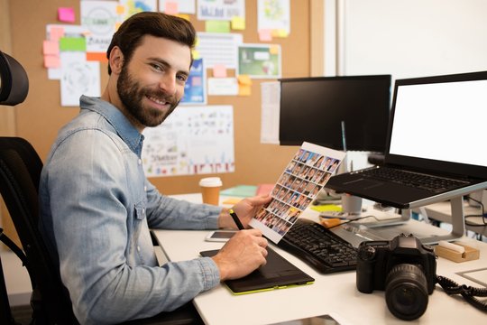 Professional designer working at desk in creative office
