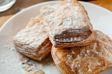 puff pastries in a white ceramic plate, closeup shot
