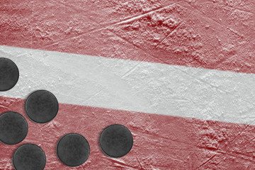 Latvian flag and hockey pucks