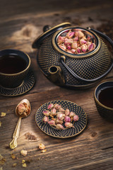 Cup of hot tea and iron teapot